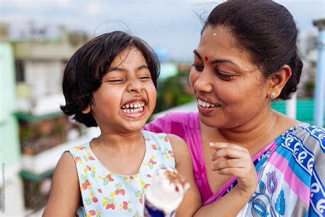 Mother And Daughter Enjoying An Ice Cream On A Hot Day By Stocksy Contributor Saptak Ganguly