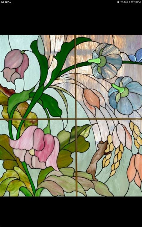 A Close Up Of A Stained Glass Window With Flowers