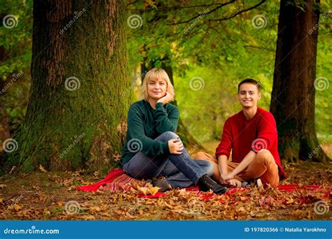 Beautiful Woman Blonde Middle Aged Walking With Her Big Son Autumn In The Park Sunny Day