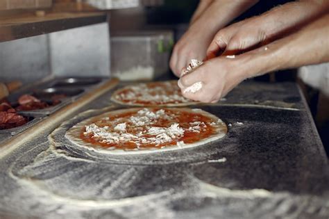 Free Photo | Chef in a white uniform prepare a pizzaa