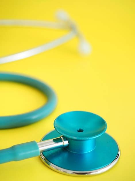 Premium Photo A Blue Stethoscope Is On A Yellow Background With A