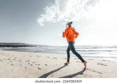 Mature Woman Jogging On Shore Beach Stock Photo Shutterstock
