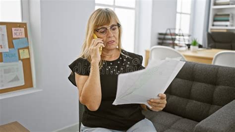 Elegant Blonde Boss Woman In Her Middle Age Relaxed Yet Seriously Engrossed In A Business
