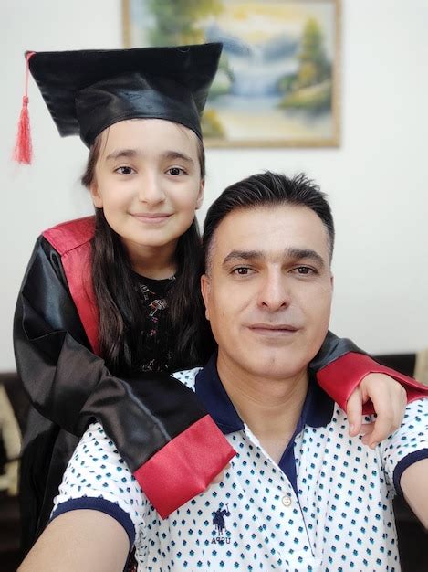 Premium Photo Portrait Of Father With Daughter In Graduation Gown