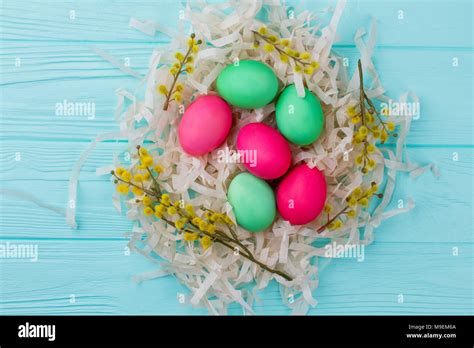 Painted Easter Eggs In Nest Colorful Easter Eggs Pussy Willow Twigs And Pile Of Paper
