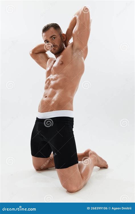 Man Athletic Body Bodybuilder In Briefs With Naked Torso Abs Full Length In The Background
