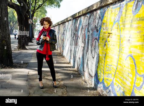 Gorgeous Brunette Woman Posing With Graffiti On The Street Stock Photo Alamy