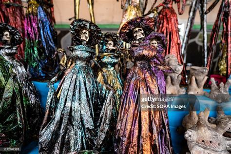 Day of the dead figurines are being displayed at a market stall in ...