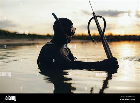 Diver Spearfishing Using A Speargun In The Sea Adventurous Young Man