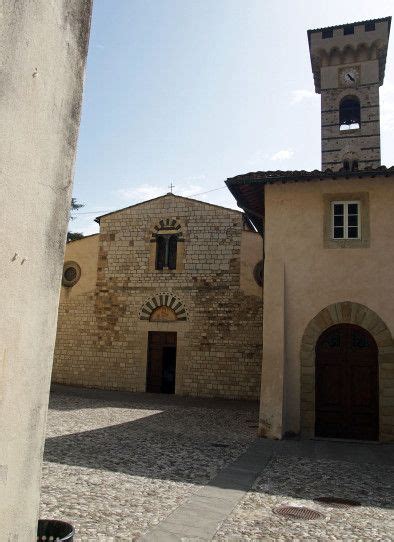 An Old Building With A Clock Tower In The Middle Of It S Courtyard And