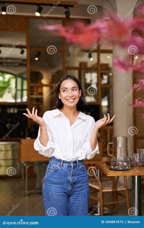 Vertical Shot Of Enthusiastic Brunette Girl Looking Excited Raising Hands Up Posing Near Cafe