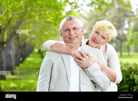 Portrait Of Happy Mature Woman Hugging Her Husband Outside Stock Photo Alamy