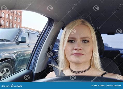 Bright Beautiful Blonde With Big Brown Eyes And Bright Makeup Takes A Selfie While Driving A Car