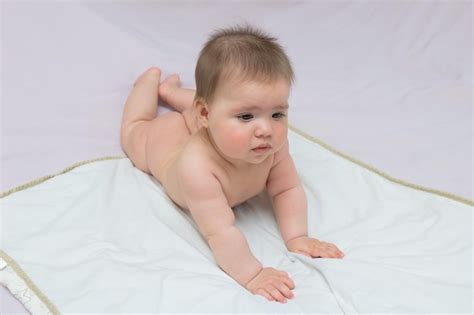 Premium Photo Baby Girl Lies Naked On A Diaper