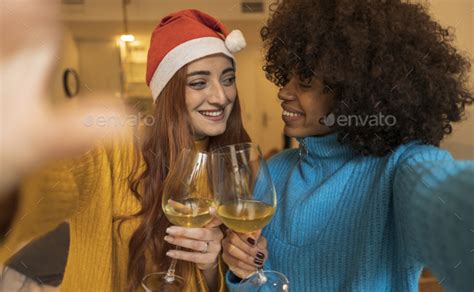 Close Up Multiracial Lesbian Couple Toast With White Wine Celebrating