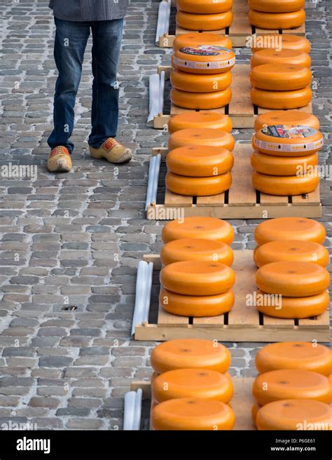 Traditional Dutch Clogs And Stacked Cheeses At The Gouda Cheese Market