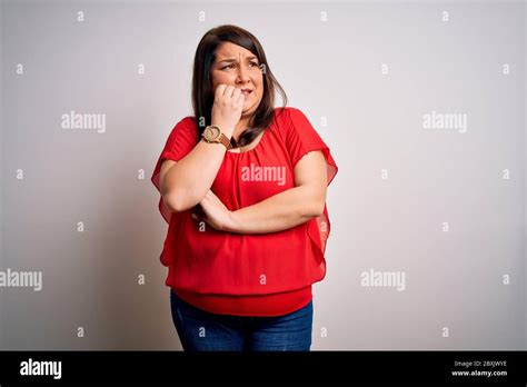 Beautiful Brunette Plus Size Woman Wearing Casual Red T Shirt Over Isolated White Background