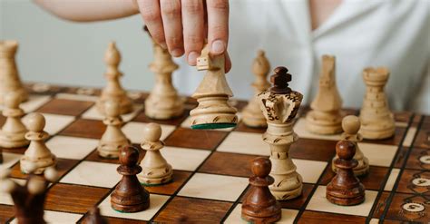 Person Playing Chess Game on Chess Board · Free Stock Photo