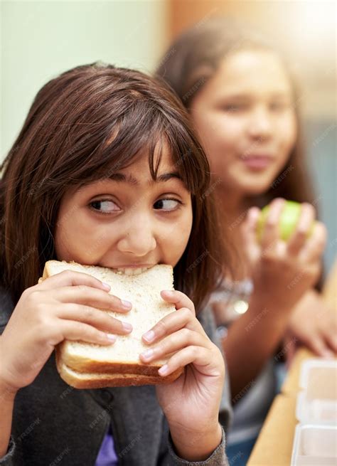 Premium Photo | Girl face and student biting sandwich for meal break or ...