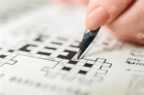 Person Using Pencil To Solve Crossword Puzzle Stock Photo Image Of