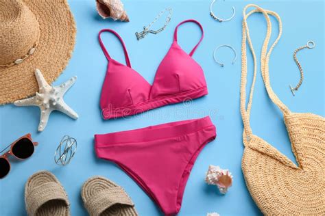 Beautiful Pink Bikini And Beach Accessories On Light Blue Background Flat Lay Stock Photo