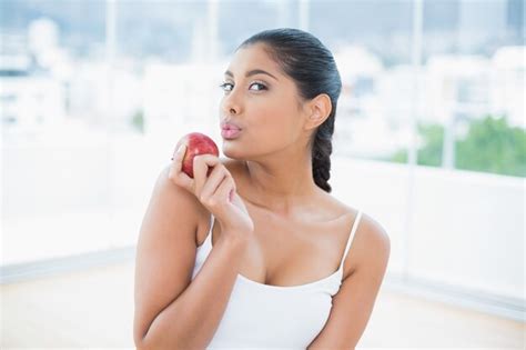 Premium Photo Calm Toned Brunette Holding Apple