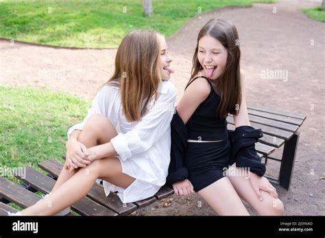 Fraternal Twins Sisters Blonde And Brunette Teen Girls In Fashionable Black And White Clothes