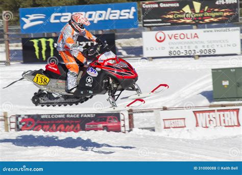 Red And Black Polaris Snowmobile Racing In Air Editorial Stock Photo