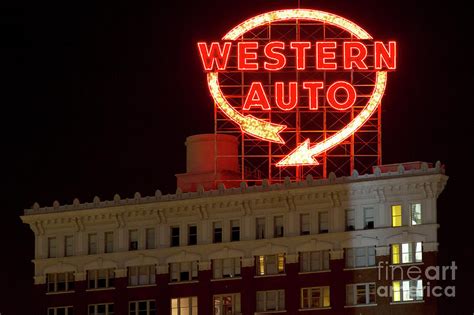 Western Auto Sign Lit at Night Photograph by Russell Honey