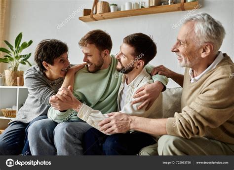 Gay Couple Sits Couch Parents Laughing Embracing Stock Photo HayDmitriy 722993756
