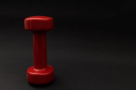 Premium Photo Little Red Weights On A Black Background