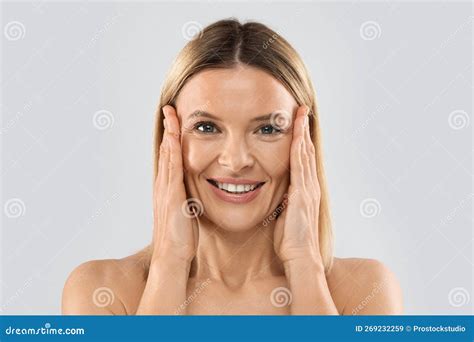 Pretty Nude Middle Aged Blonde Woman Touching Face Closeup Stock Image