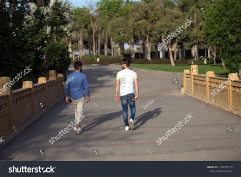 Back View Two Friends Walking Together Stock Photo