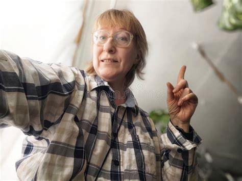Blonde Middle Aged Woman Takes A Cheerful Selfie Indoors While Blogging About Lifestyle Tips