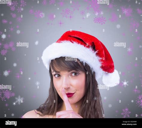 Composite Image Of Festive Brunette Keeping A Secret Stock Photo Alamy