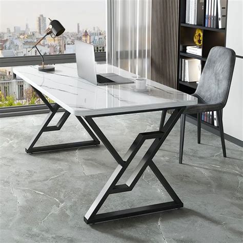 an office desk with a laptop on it in front of a window overlooking the ...