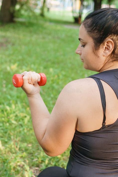 A Charming Brunette Woman Plus Size Body Positive Practices Sports In