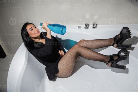 Sexy Brunette Posing In A Bathtub 20041612 Stock Photo At Vecteezy