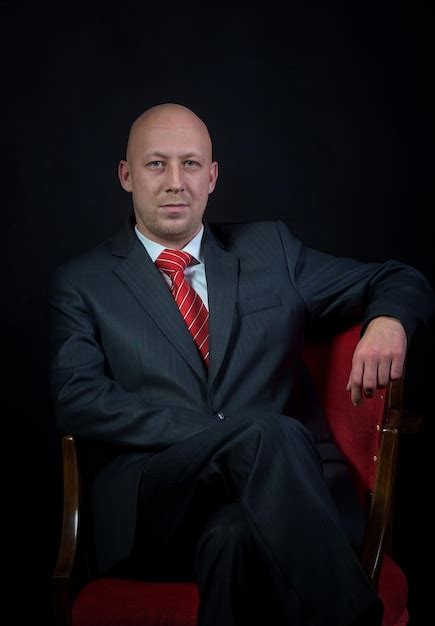 Premium Photo Man Sitting In The Armchair Dark Background