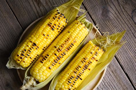 sweet corn food , sweet corn cooked on wooden plate background, ripe