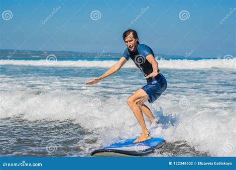 Young Man Beginner Surfer Learns To Surf On A Sea Foam On The B Stock