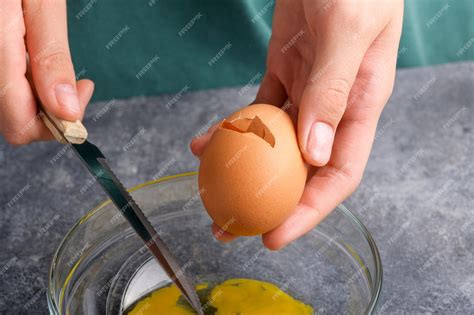 Premium Photo A Cracked Egg In The Hand Close Up A Womans Hand