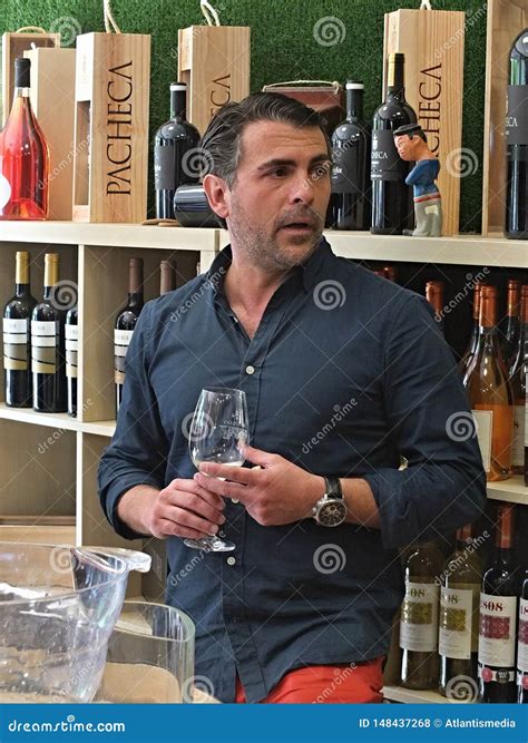 Expert Explaining and Preparing Quality Wine for a Tasting Editorial