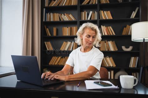 Confident Stylish Middle Aged Senior Woman Using Laptop At Workplace Older Mature Lady
