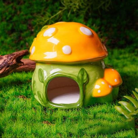 A Green And Yellow Mushroom House Sitting In The Grass