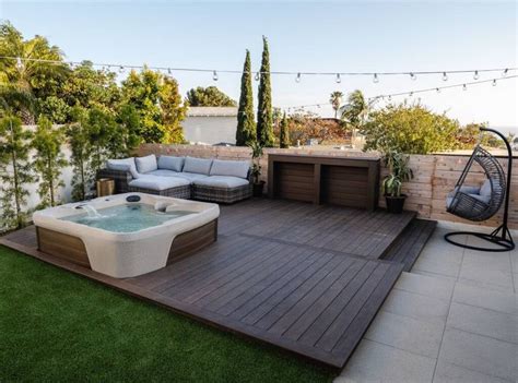 Backyard Oasis Hot Tub On Wooden Deck With Lush Green Field View