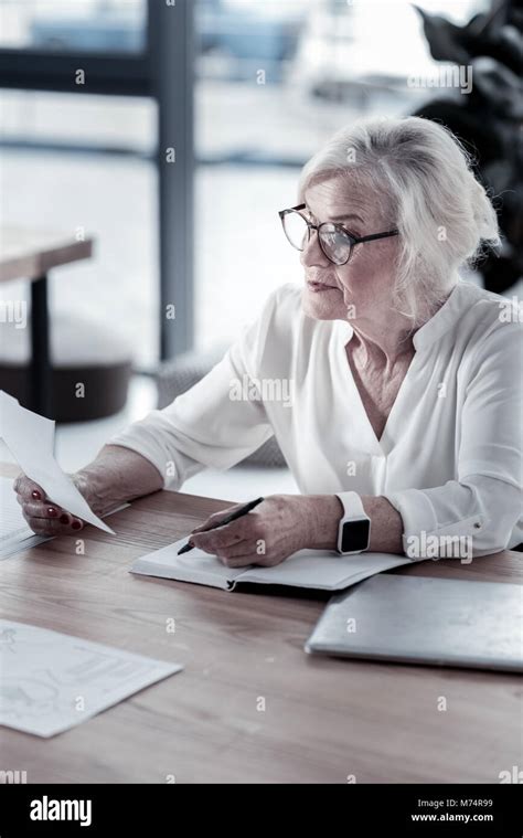 Attentive Mature Blonde Counting Result Stock Photo Alamy