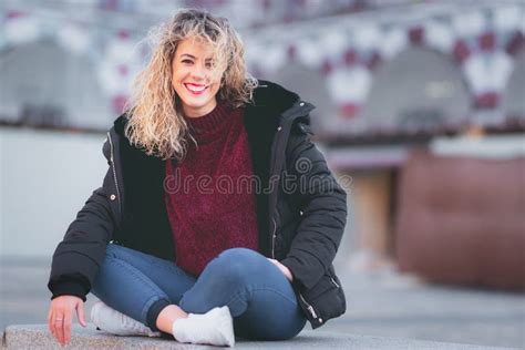 Curly Blonde Woman Sitting On Bech Casual Clothes Stock Photo Image Of Happy Blurred