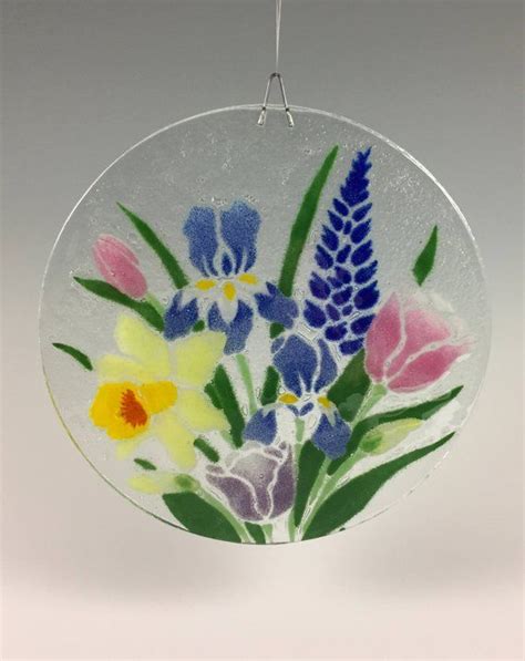 A Glass Ornament With Flowers Painted On It