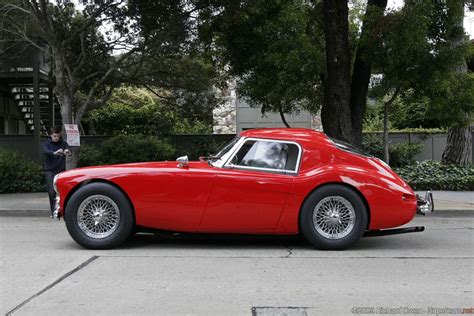 An Old Red Sports Car Parked On The Street